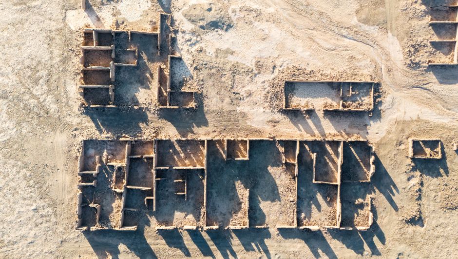 Aerial view of an archaeological site being surveyed with a drone, showcasing advanced technology in site assessment.